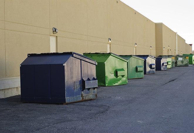 a fleet of red and blue construction dumpsters available for use in Burnsville